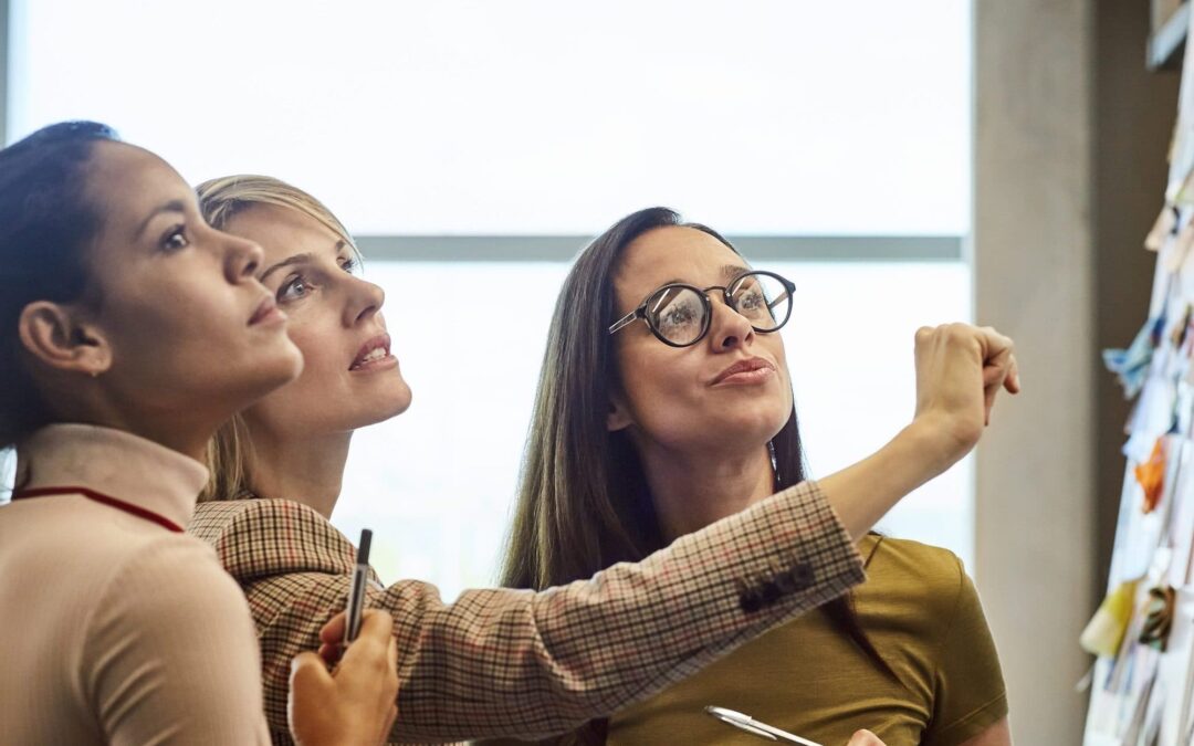 Businesswomen looking at fabric samples on board